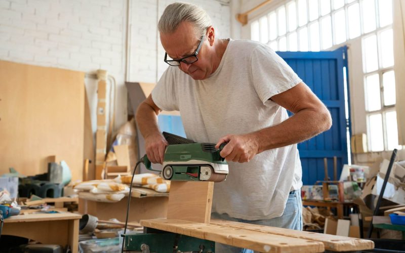 carpenter-working-on-wood-craft-at-workspace-producing-wooden-furniture-.jpg